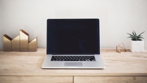 A freelancer reviewing a detailed project specification document on a laptop screen