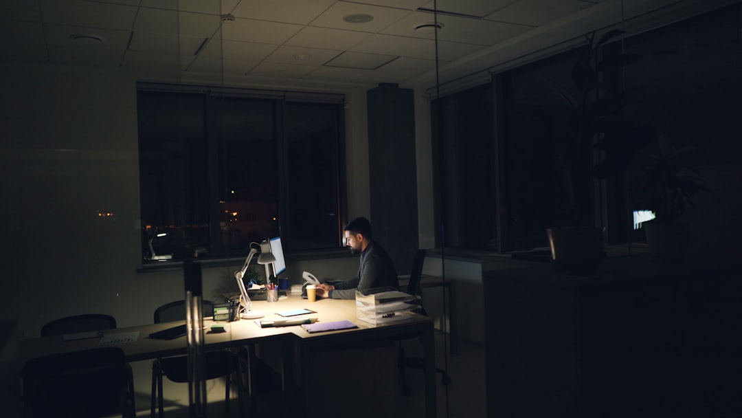 A business owner reviewing financial documents with a 20% rule calculation visible on screen