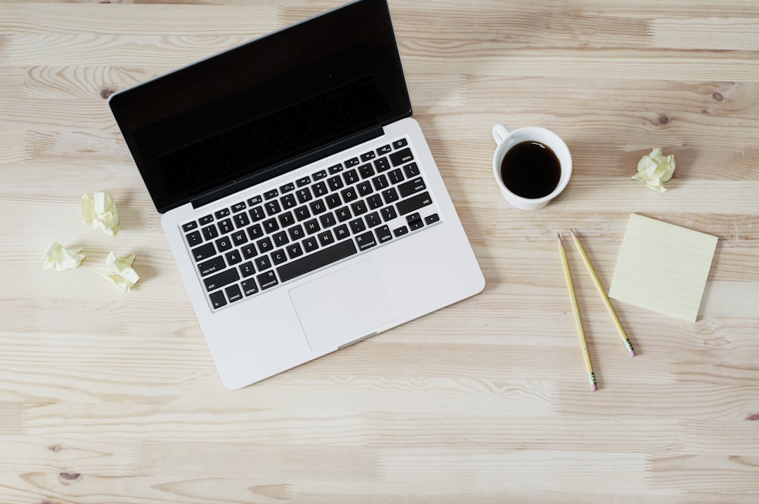 A freelancer looking at a laptop screen with a 48-hour rule checklist visible on the monitor.