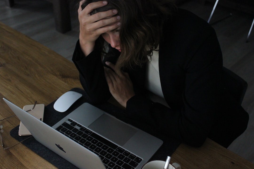 A person sitting at a desk with an AI interview coach interface, looking stressed and unsure