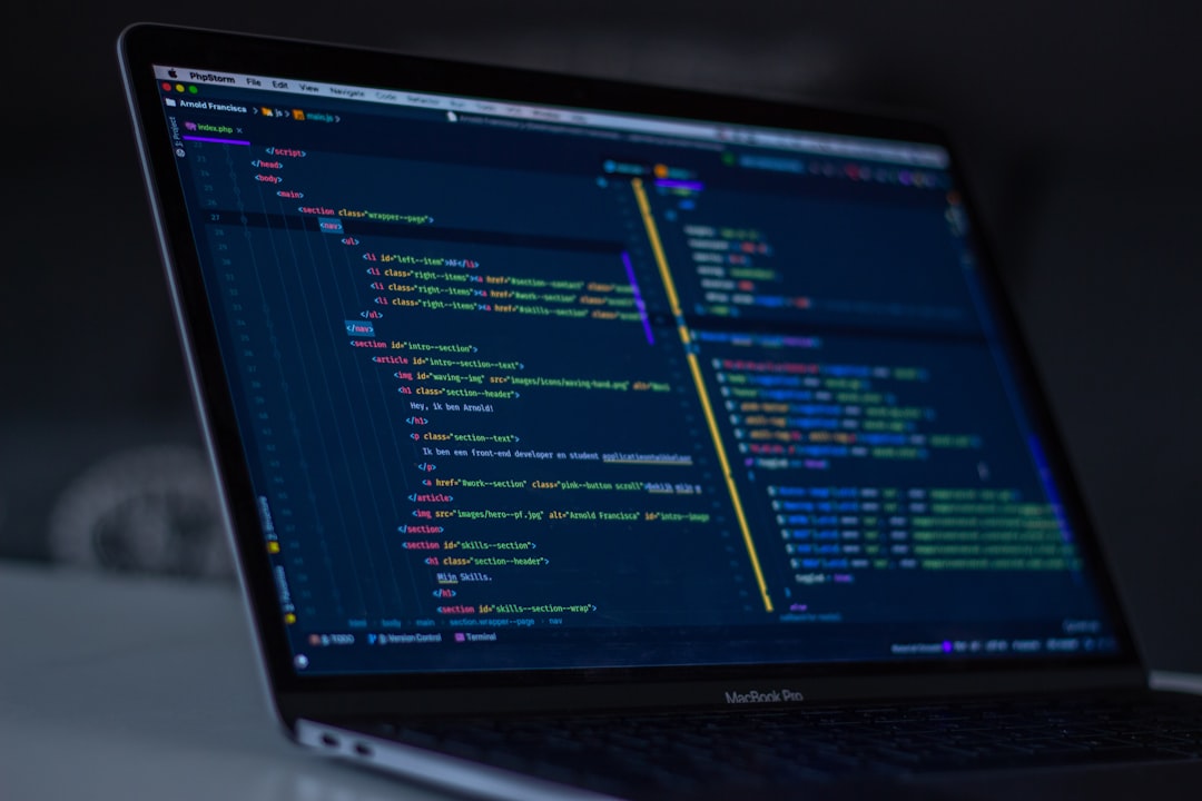 Developer using Cursor agent mode on a laptop screen with code visible