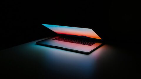 Three laptop screens showing cursor vs windsurf vs replit ai interfaces side by side